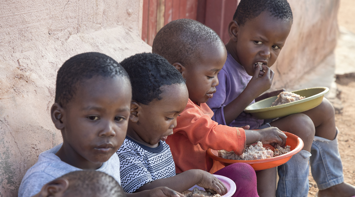 African boys eat porridge