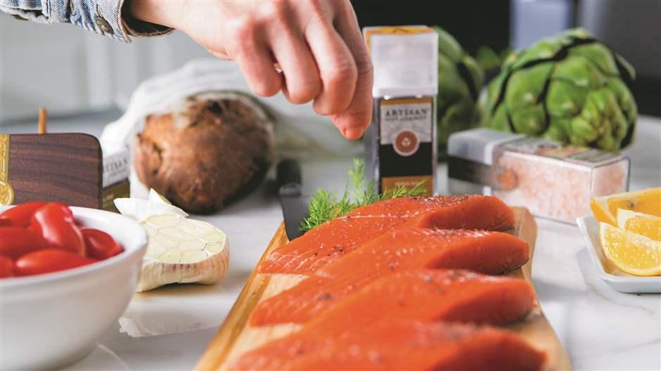 Person Salting Salmon Fillets