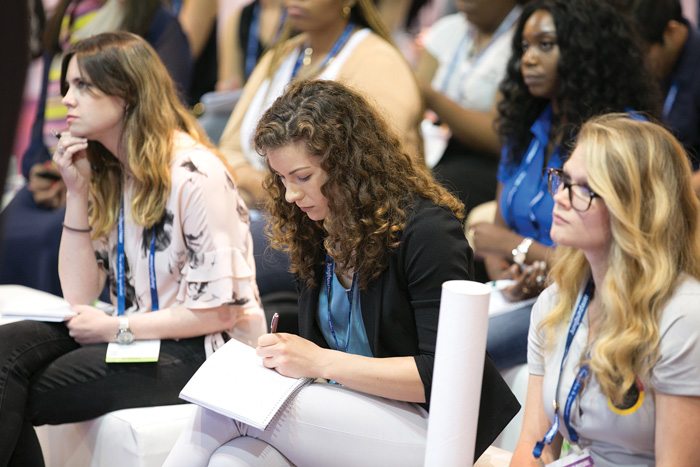 taking notes at presentation