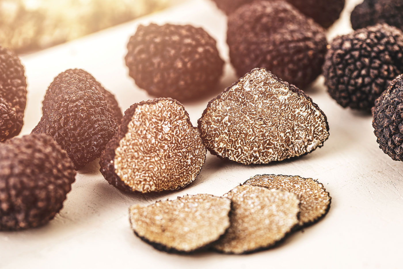 Close up of black truffle mushrooms, whole, half and sliced