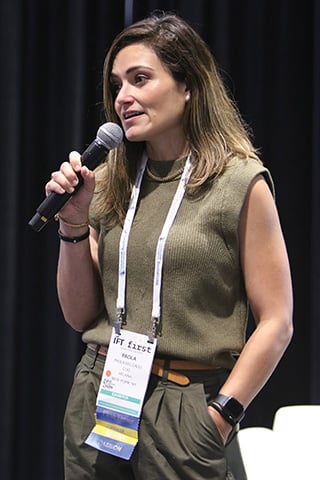 Paola Delgado speaking into a microphone at IFT FIRST