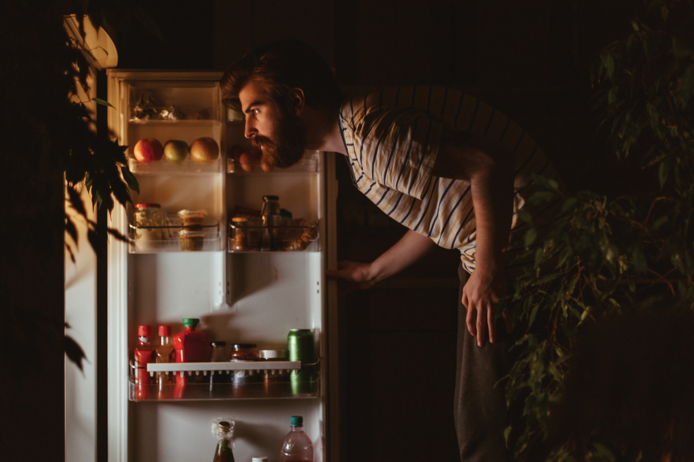 Looking in the fridge for a late night snack.