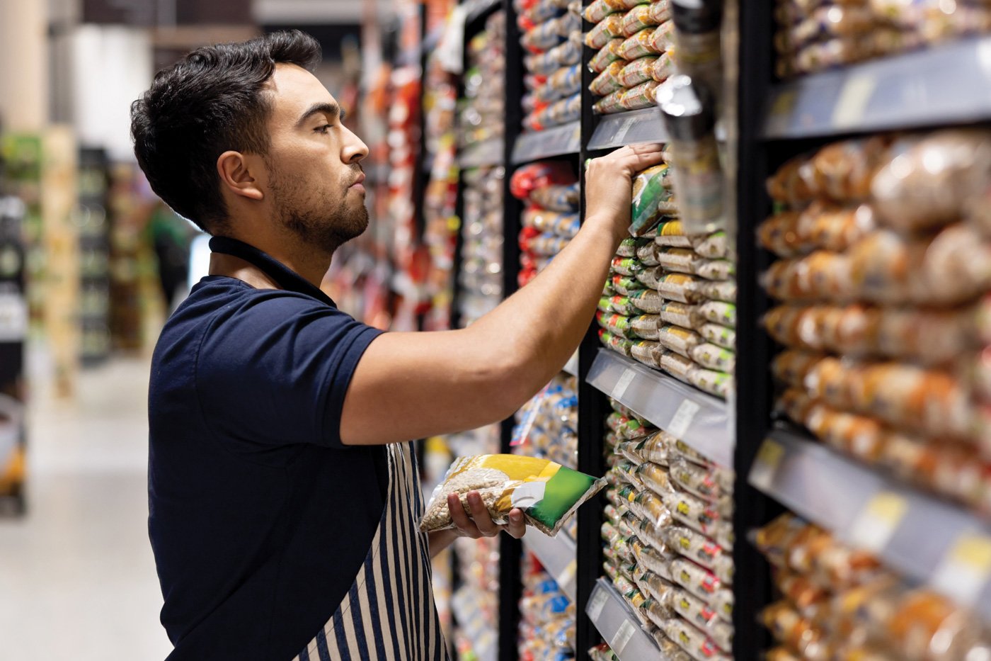 Man stocking shelf in a grocery store