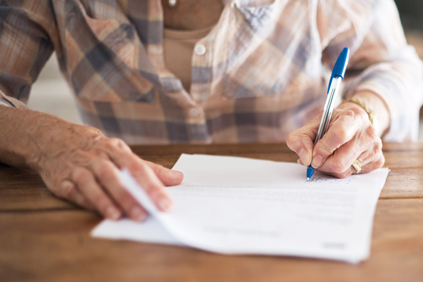 senior woman filling in paperwork