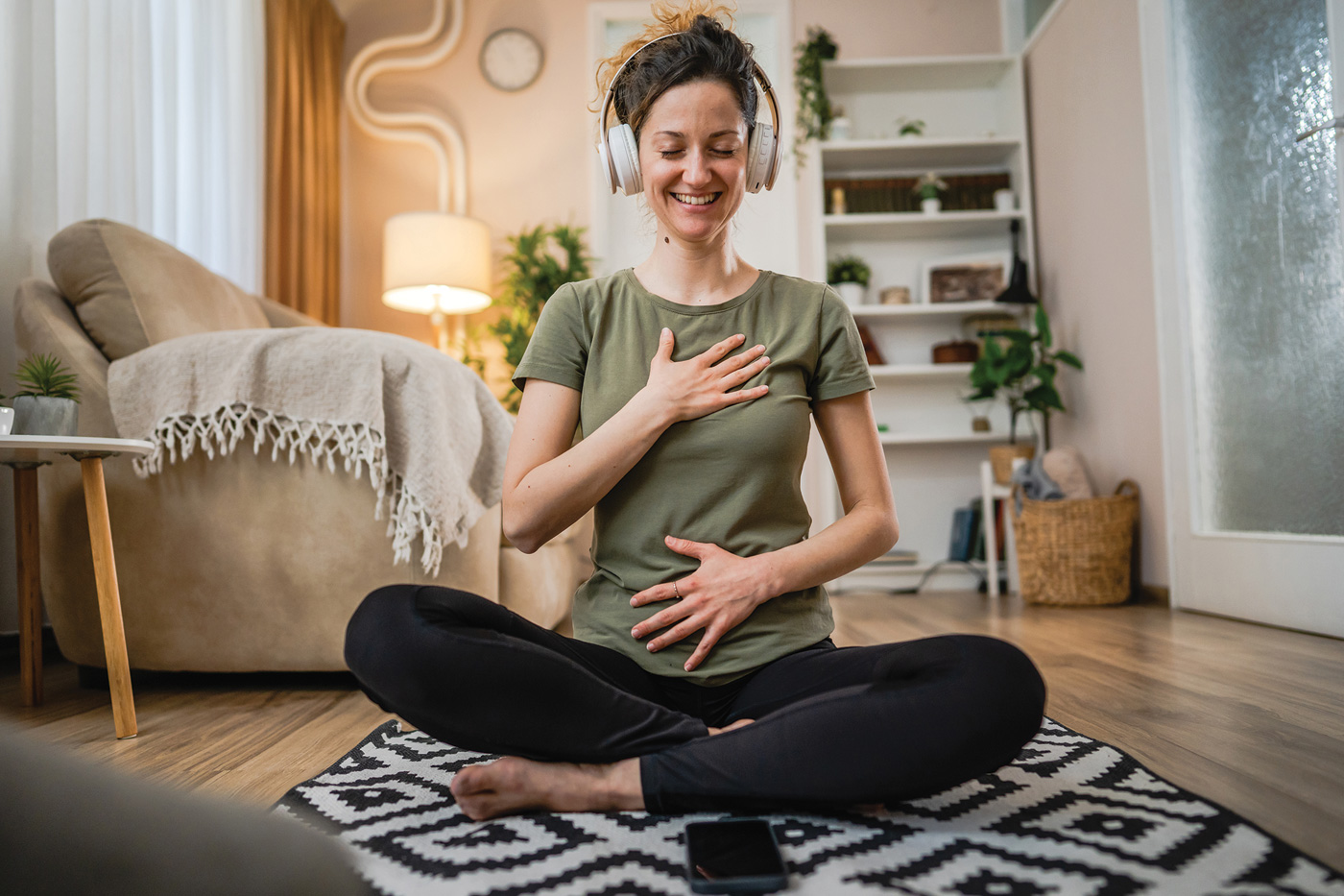 woman using headphones for online guided meditation