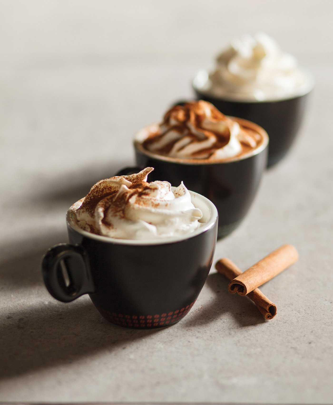 Coffee with swirled whipped cream and cinnamon sprinkled on top, 