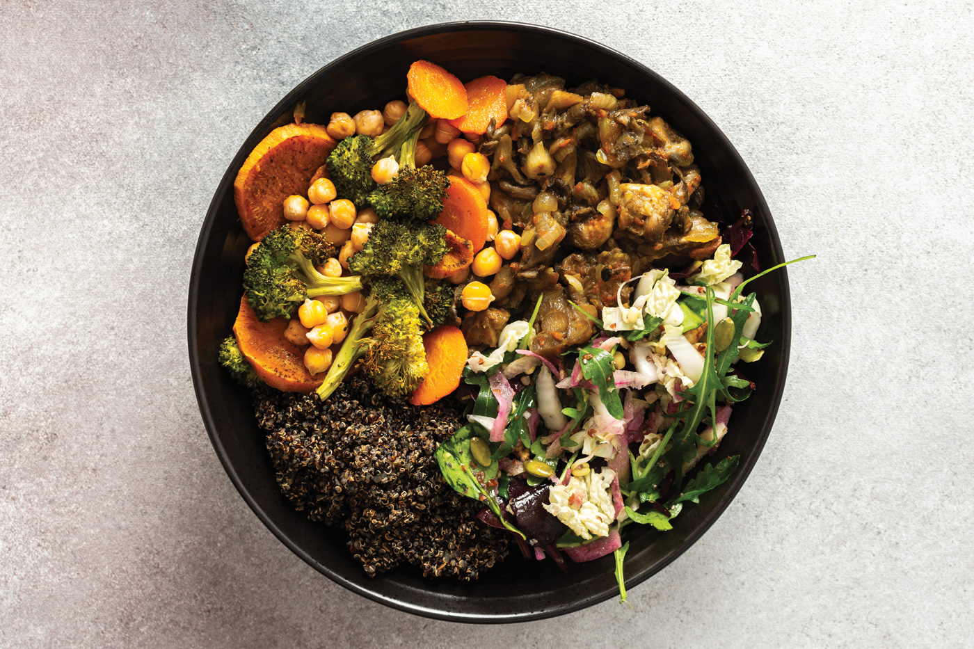 A filling, balanced breakfast with black quinoa, avocado, roast chicken, sweet potatoes, zucchini, broccoli, and a refreshing cabbage and radish salad with chia and sesame seeds