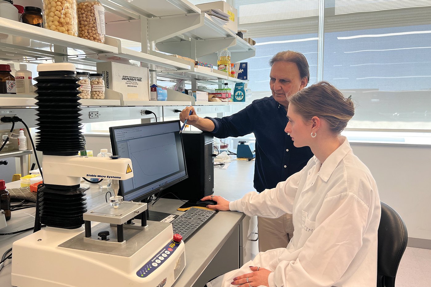 Professor Syed Rizvi, who leads a Cornell University lab focused on developing novel processes for new food products, and PhD student Jessica Uhrin, a researcher in the lab, analyze one of the puffs the lab group created. 