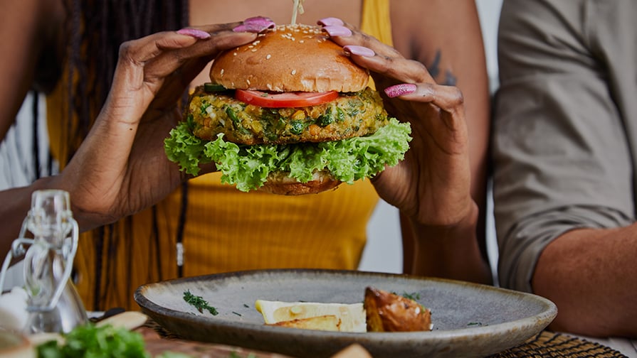 person eating a plant based burger