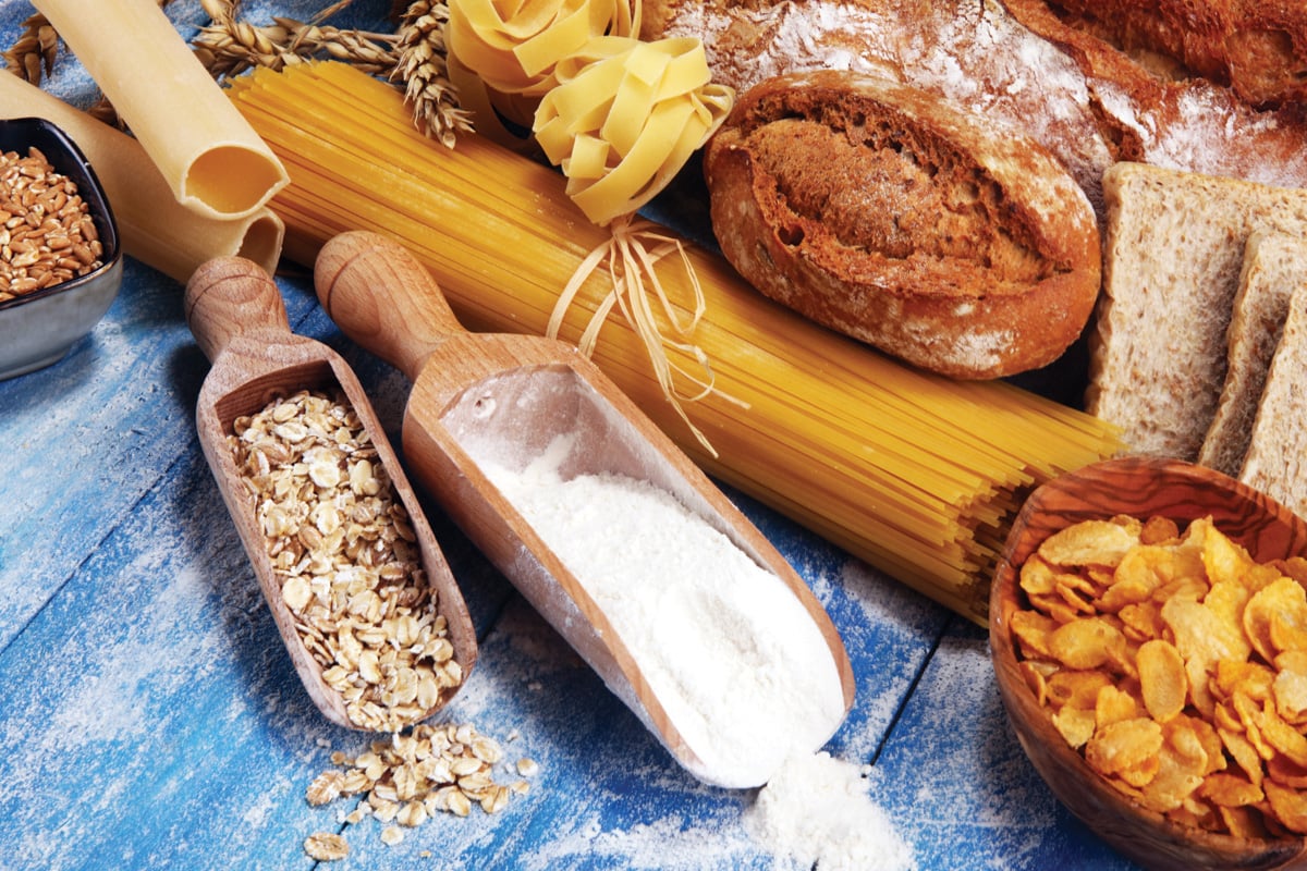 Whole grain products with complex carbohydrates on rustic table.