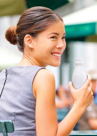 Woman enjoying protein beverage.