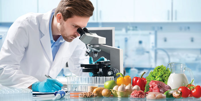 Scientist looking through microscope